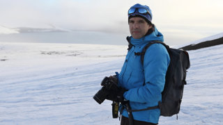 Enric in the snowy expanse of Franz Josef Land in Russia with camera equipment.