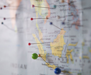 Map close-up of Indonesia and Malaysia with pins stuck in different places.