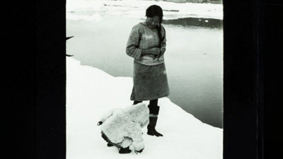 Old black and white photograph of an Inuit woman and child, British East Greenland expedition 1935-36.