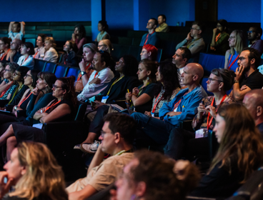 Delegates watching a lecture at the annual conference in 2024, in the Ondaatje Theatre