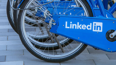 Close up of a row of blue byclies with the LinkedIn logo printed on the chain guard.
