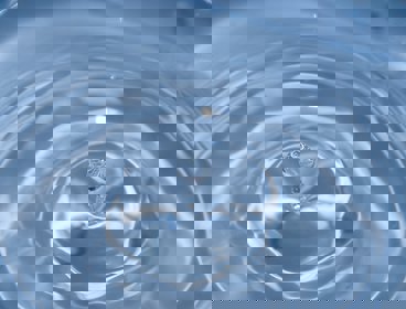 A water drop falling into water