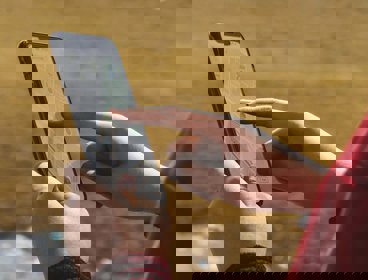 Hands holding a phone that shows a map on the screen