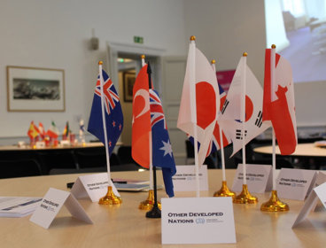 Table with flags representing different nations at a COP event.