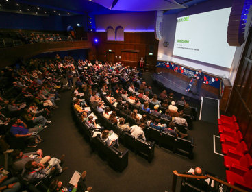 RGS Director Joe Smith welcomes attendees in the Ondaatje Theatre during the Explore 2024 opening address.