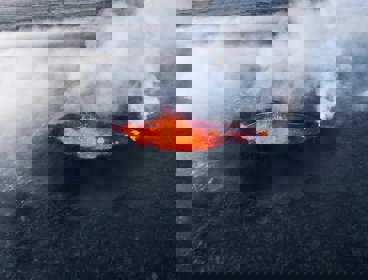 A volcanic crater with lava and gases
