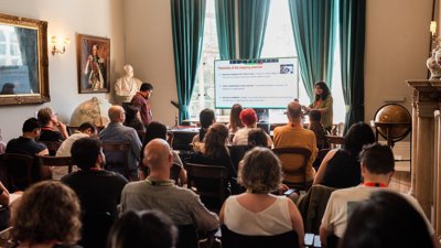 Presentation to audience in historic room at Royal Geographical Society.