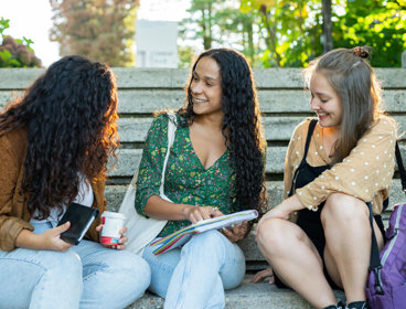 People sitting on stone steps whilst chatting
