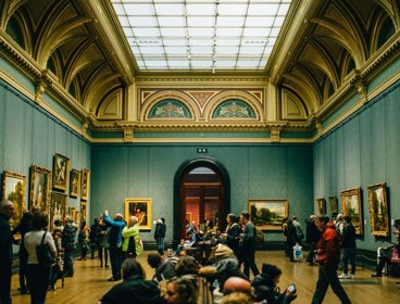 Busy gallery space with people.