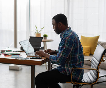Person sat at desk using a laptop