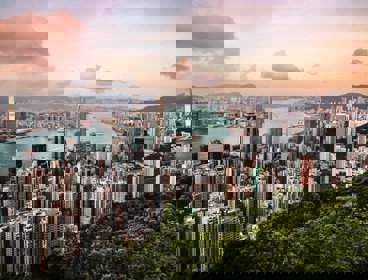 A view over Hong Kong, showing a cityscape, river and woodlands