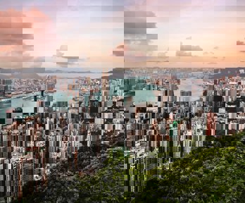 A view over Hong Kong, showing a cityscape, river and woodlands