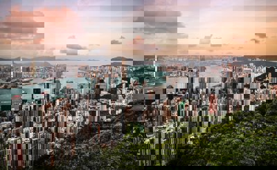 A view over Hong Kong, showing a cityscape, river and woodlands