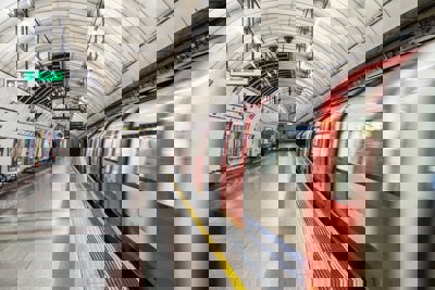 A London Underground train leaving a platform