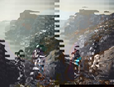 Two feet with a coastal area in the distance