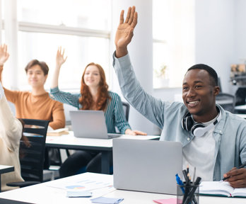 Portrait of smiling diverse people of students raising hands at seminar.