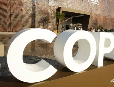 White COP30 sign outside of conference centre.