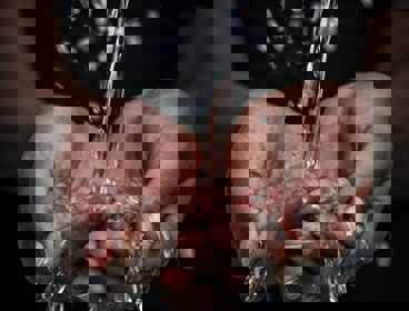 Hands with water running through them