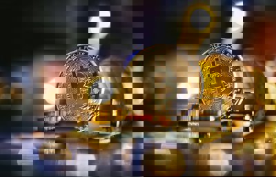 A bitcoin sitting on top of a computer chip