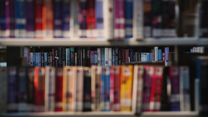 Colourful library books on a shelves.