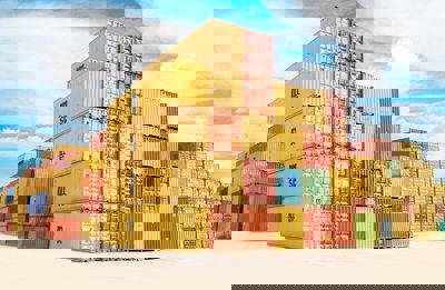 A pile of yellow and orange shipping containers