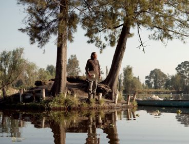 A traditional Chinampero farmer and agroecology teacher on island surrounded by water.