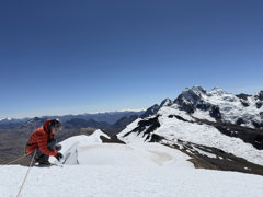 A grant recipients collects snow samples from the summit of a big mountain (Suyuparina in Peru).