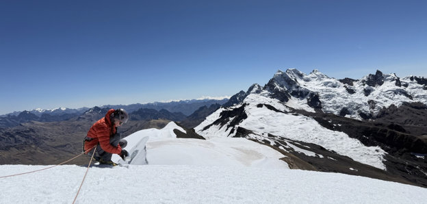 A grant recipients collects snow samples from the summit of a big mountain (Suyuparina in Peru).