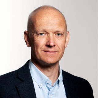 Headshot of Steve Jones wearing a formal jacket and shirt.