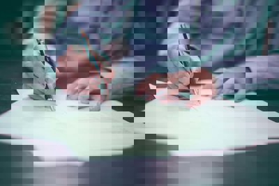 Person writing on paper