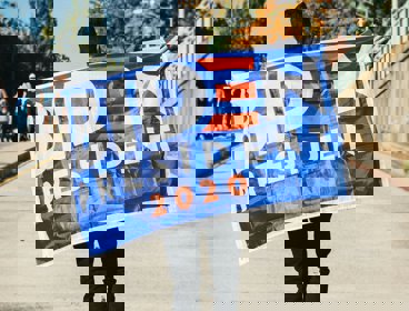 Man holding a Biden banner