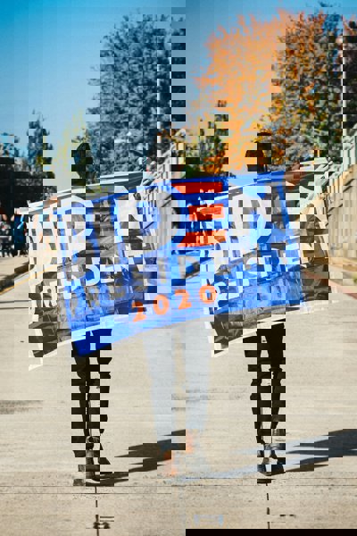 Man holding a Biden banner