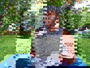 A person holding a sign that says # Choose Geography