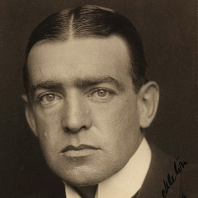Ernest Shackleton is looking directly at camera, wearing a suit, his hair is parted