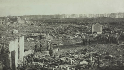 Damaged French city of Lille, during German Occupation, World War I, 1916. People stand scattered amongst debris. Almost all buildings are entirely destroyed.