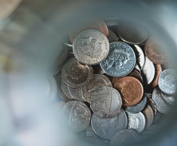 Sterling coins in a jar.