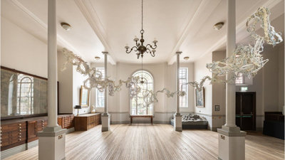 Dreading the map' art installation by Sonia E. Barrett. The installation shows paper maps that have been shredded into strips.