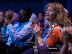 Audience applauding in a lecture theatre.