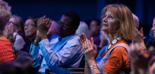 Audience applauding in a lecture theatre.