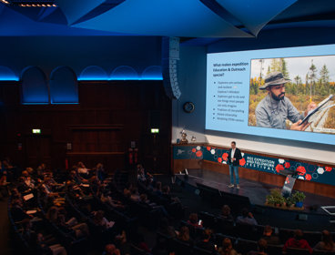 Speaker Tim Jacobs stood on stage in the Ondaatje Theatre at Explore 2022.
