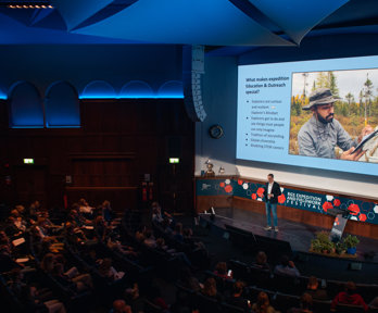 Speaker Tim Jacobs stood on stage in the Ondaatje Theatre at Explore 2022.
