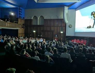 Audience watching a film in a theatre.