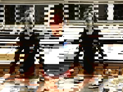 Someone stands next to a table with various artefacts. They are wearing a NASA t-shirt.