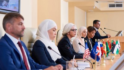 people at conference table with flags