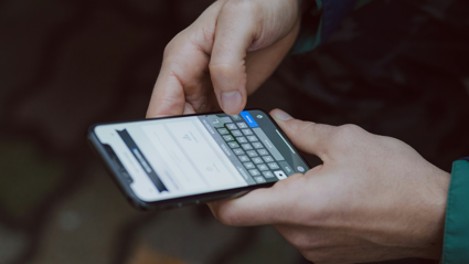 A person texts on their smartphone.
