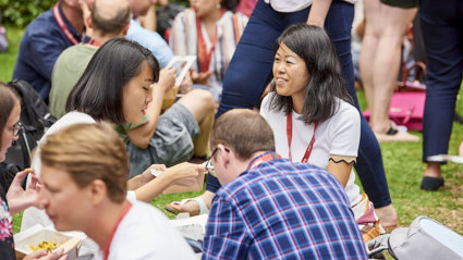 Conference delegates networking over lunch in the garden