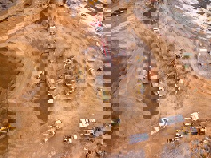 Aerial photography of dumper trucks and other industrial vehicles located in a mining area