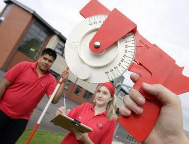 Children in a playground using fieldwork equipment
