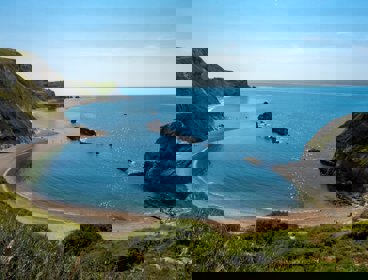 A view over Lulworth Cove in sunshine