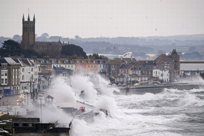 A cornish coastal sea front being battered by large foamy waves